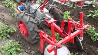 First hilling potatoes after planting tractor.