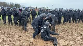 Robed ‘Wizard’ Taunts Police Struggling in Mud