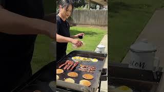 Woman is cooking breakfast for her family on the Blackstone grill!