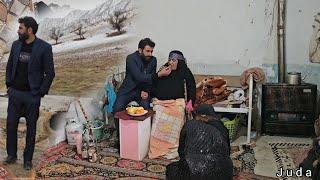 Engineer Babazadeh helping the elderly woman and Mrs. Juda taking care of her