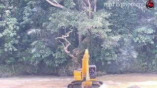 Komatsu PC 200 excavator stuck in the middle of the river