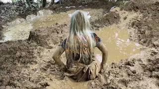 A maid girl tried to submerged in mire.