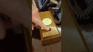 Trump shows off the coke button on his desk in the oval office