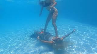 Double underwater fun 2 girls at the bottom of the swimming pool