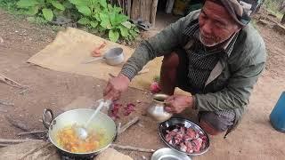 the old man cooking and eating