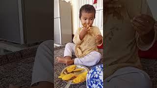 Uzman Watto is eating Mangoes