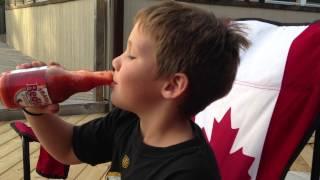 Kid tries Frank's red hot sauce right from the bottle