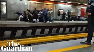 People run for cover as Iranian police open fire during protest at Tehran metro station