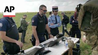 British paratroopers have passports checked after parachuting into France for D-Day event