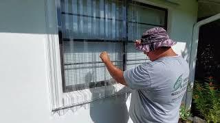 Home Safety Solutions deploying clear hurricane panels using a header and sill system.