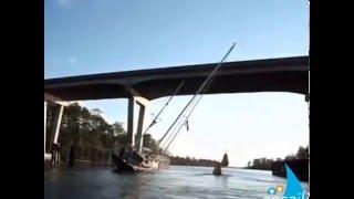 Sailing a Boat Under a Low Bridge