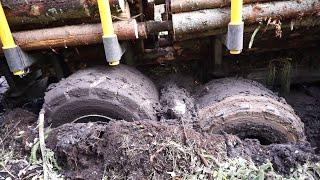 Valtra T144 with large trailer Kronos 160 4WDM logging in wet forest, stuck in the mud