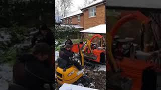 Hiab collecting waste from inside a garden PCRS rental machines