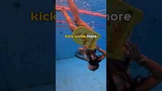 Can girl stand on kickboard underwater?