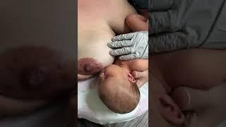 Sleepy baby at the breast