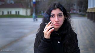 A big-eyed girl is smoking 100mm cigarette