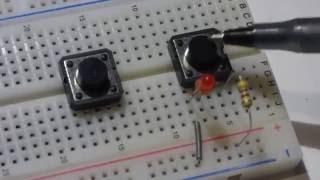 Normally open tactile push button switch. How to insert into breadboard and use in an LED circuit.