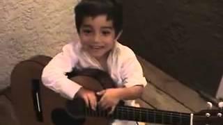 Little kid singing and Playing guitar