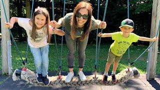 Lika and Andrew play on the kids playground with mommy