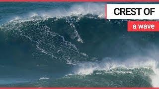 Brit surfer breaks new world record for taking on biggest wave | SWNS TV