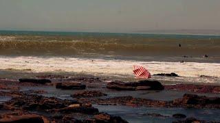 The escape of the red striped beach umbrella -Surfing West Coast of  South Africa