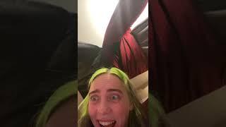 Billie Eilish fits a ukelele in her mouth