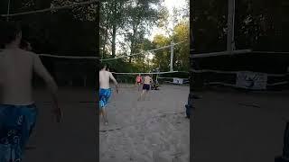 Beach volleyball, the player hit the ball successfully through the center.