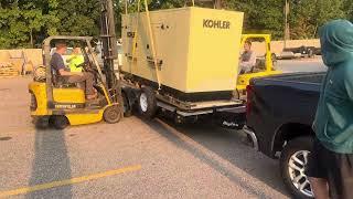 How to unload a heavy generator with two forklifts off a trailer