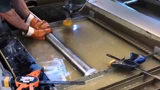 Using a custom made jig to cut slots in a tube.