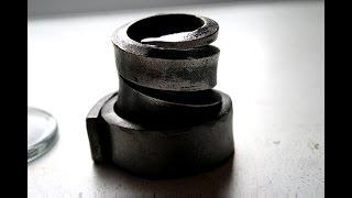 Hand forging a candle holder.