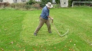 Autumn mowing lawns and meadows with a scythe