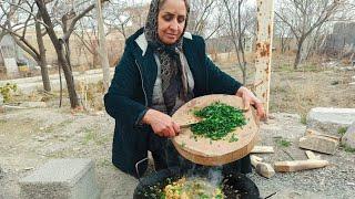 Healthy and vegetarian lifestyle in the village.Cooking spinach pilaf in nature.Village winter