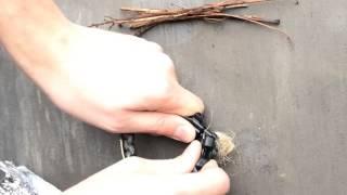 Starting a fire with striker and flint on survival bracelet