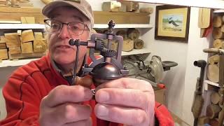 An antique style grinder with a chestnut body and walnut base