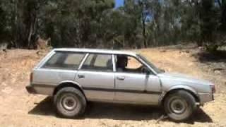 subaru with modified landcruiser rims in a dam