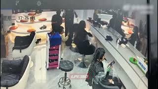 A girl cuts a woman's hair in a salon