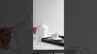 A Person Pouring Water on a Tea Cup