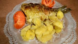 Carp baked in the oven with potatoes. Fast dinner.