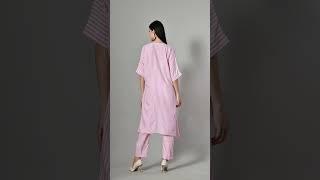 A celebration of color and comfort, this oversized V-neck top in vibrant candy pink.