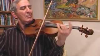 Michail Kazinik tries out a violin made in 1741 by Guarneri