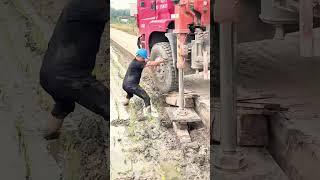 The process of manually fixing the wheel of a truck that has run off the road