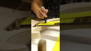Kaila Kiesel masking a guitar for paint