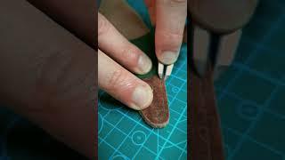 Creating a stitch line for a cisor sleeve made by hand. Leathercraft skills ambience.