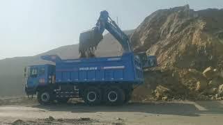 KNOW-HOW ELECTRIC DUMP TRUCK AND EXCAVATOR,CONSTITUTE A BEAUTIFUL GREEN SIGHT ON THE MINING