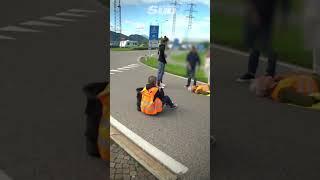 Eco protester knocked to the floor by car at protest