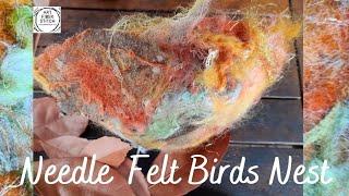 Needle felt mixed media birds nest with wool, silk, fabric, felt, leaves and feathers.  #fiberart