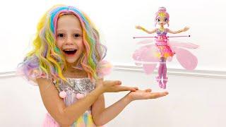 Nastya is dancing with a new flying doll at home