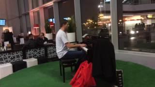 Passenger play public piano in Warsaw International airport