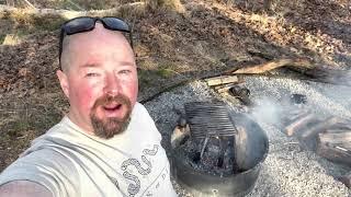 Campfire roasted bratwurst peppers and onions with baked beans.