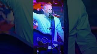 Kevin Costner, currently 70, singing and playing guitar.